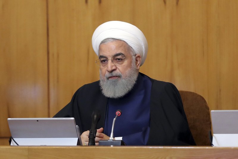 In this photo released by the official website of the office of the Iranian Presidency, President Hassan Rouhani heads a cabinet meeting in Tehran, Iran, Wednesday, May 8, 2019. Rouhani said Wednesday that it will begin keeping its excess uranium and heavy water from its nuclear program, setting a 60-day deadline for new terms to its nuclear deal with world powers before it will resume higher uranium enrichment. (Iranian Presidency Office via AP)