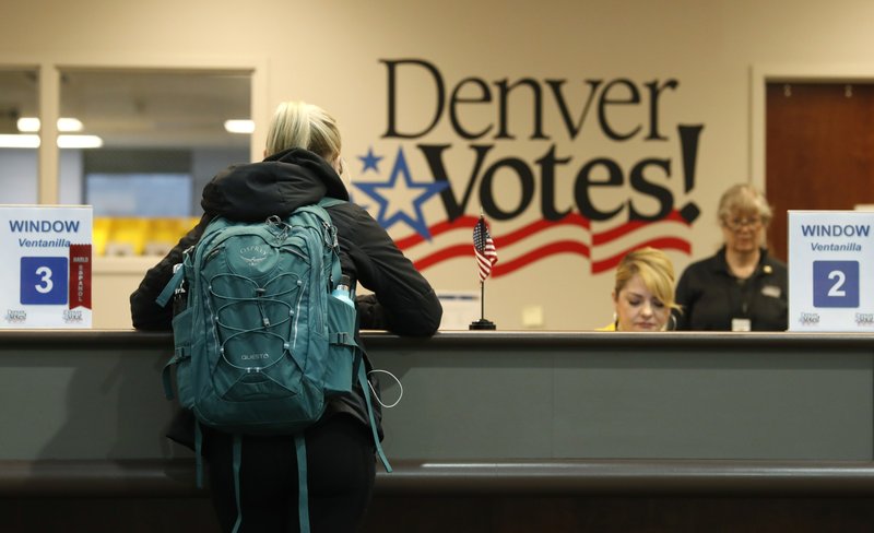 A voter fills out her ballot at the Denver Elections Division Tuesday, May 7, 2019, in Denver. Voters could make Denver the first U.S. city to decriminalize the use of psilocybin, the psychoactive substance in "magic mushrooms" if the measure passes. (AP Photo/David Zalubowski)