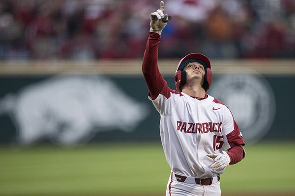 Arkansas shortstop Casey Martin points toward the sky after hitting a home run during the first inning of a game against LSU on Thursday, May 9, 2019, in Fayetteville. 