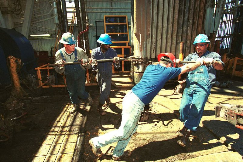 Anadarko Petroleum Corp. employees tighten a section of pipe to the drilling mechanism on board an oil drilling platform in the Gulf of Mexico in 2001. Anadarko is prized for its oil fields across west Texas and eastern New Mexico. 