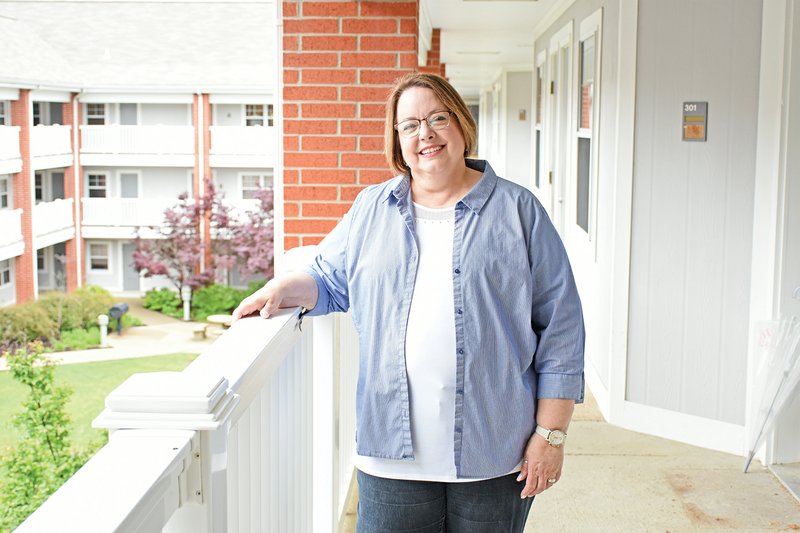 Katrina Timms stands on the third floor of Pryor Hall at Harding University in Searcy. Timms, 63, has been a dorm mother for 30 years. She and her husband, Tony, raised four children on campus. Her daughter Mica said her mother was perfect in her eyes: “I don’t know how she pulled it off, but I always felt like she was 100 percent present, mentally and emotionally.”
