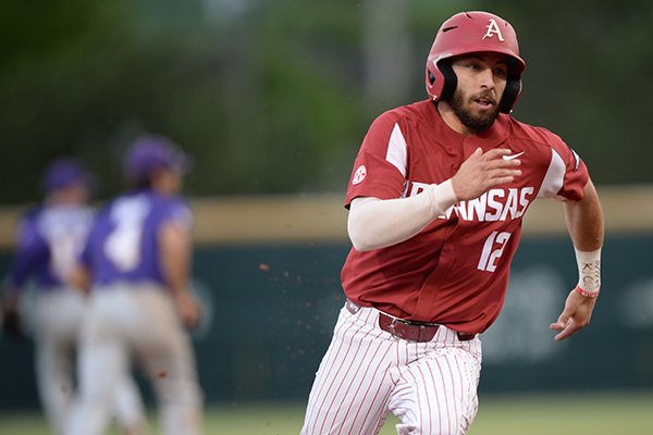 Arkansas catcher Casey Opitz heads to the plate Friday, May 10, 2019, on a double by left fielder Christian Franklin during the third inning against LSU at Baum-Walker Stadium in Fayetteville.