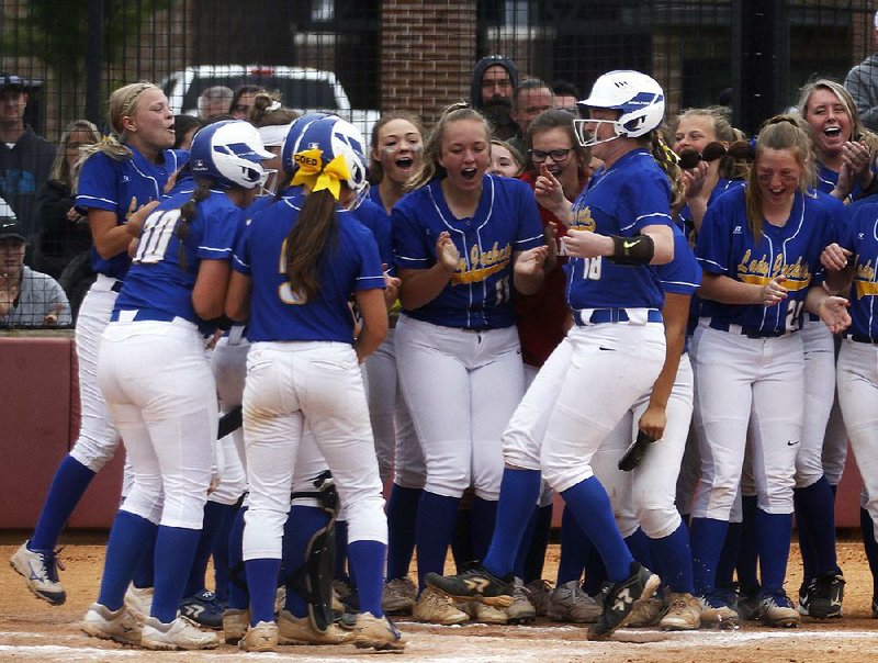 Sheridan’s Bailee Bibb (center) celebrates with teammates after hitting a three-run home run in the Lady Yellowjackets’ victory over Beebe on Friday in Benton. For more photos, see arkansasonline.com/511softball5a. 