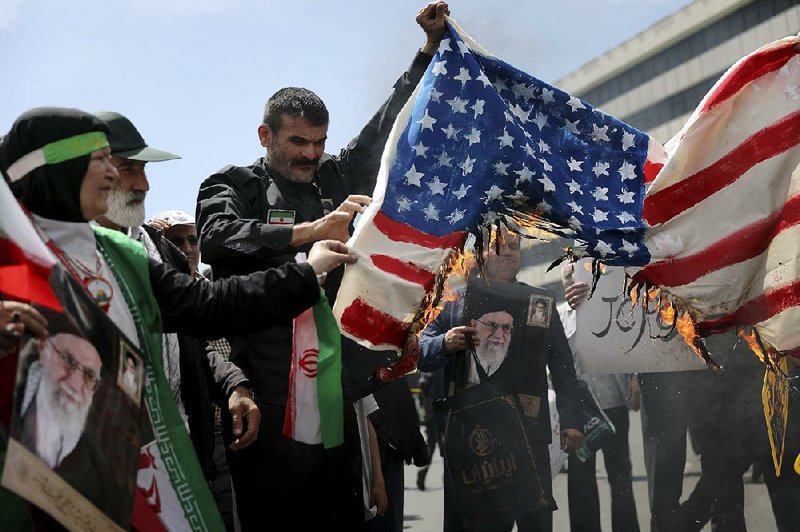 Iranians burn a makeshift American flag Friday in Tehran during a protest after prayers. 