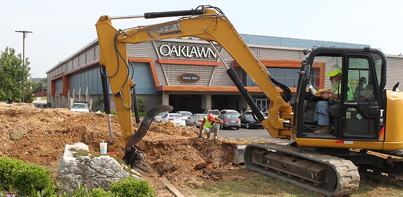 The Sentinel-Record/Richard Rasmussen CHANGE COMING: A backhoe operator digs a hole at Oaklawn Racing Casino Resort Tuesday. According to Jennifer Hoyt, media relations manager for Oaklawn, construction crews are on site beginning work on the new $100 million expansion.