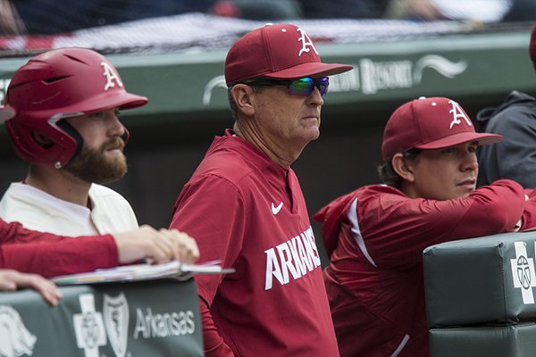 Trevor Ezell (from left), Arkansas first baseman, Dave Van Horn, Arkansas head coach, and Harrison Heffley, student assistant watch from the dugout in the 5th inning vs LSU Saturday, May 11, 2019, at Baum-Walker Stadium in Fayetteville.