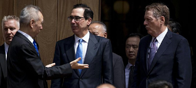 U.S. Treasury Secretary Steve Mnuchin (center) speaks with Chinese Vice Premier Liu He (left) as trade talks concluded Friday after only a few hours. Mnuchin called the talks “constructive.” 