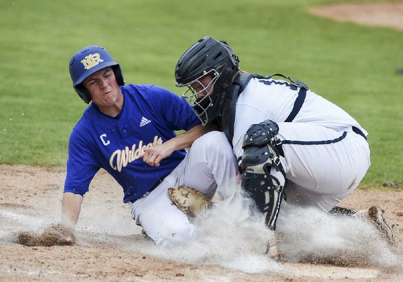 North Little Rock’s Grant Shahan slides home for a score as Bentonville West’s Zach Trammell attempts to tag him during a Class 6A state baseball tournament semifinal Saturday at Veterans Park in Rogers.