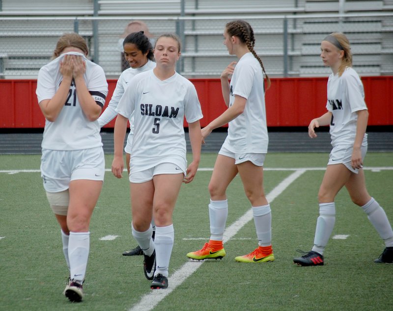 Graham Thomas/Siloam Sunday A dejected group of Lady Panthers walk off the field moments after losing 1-0 to Searcy on Friday in the Class 5A quarterfinals, ending the Siloam Springs' girls run of five straight state championships.