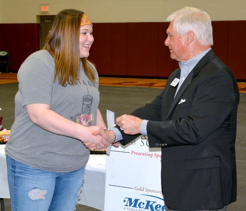 Janelle Jessen/SIloam Sunday Makayla Whorton, left, received her Arkansas Scholars award from Wayne Mays, president of the Chamber of Commerce, during a special lunch on Thursday to honor students who earned the designation.