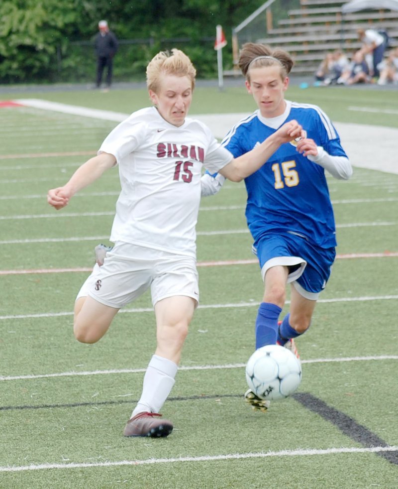 Graham Thomas/Siloam Sunday Siloam Springs' Sam Jackson, left, tries to outrun Mountain Home's Gage Slaughter to the ball during Saturday's 5A State Semifinal game in Searcy. Siloam Springs defeated Mountain Home 1-0.