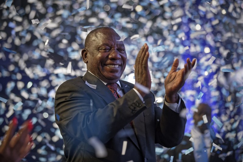 President Cyril Ramaphosa applauds as confetti is launched at the end of the results ceremony at the Independent Electoral Commission Results Center in Pretoria, South Africa Saturday, May 11, 2019. South Africa's ruling African National Congress on Saturday marked its weakest victory in national elections in a quarter-century, while Ramaphosa declared that the vote had given him and others &quot;a firm mandate to build a better South Africa for all.&quot; (AP Photo/Ben Curtis)
