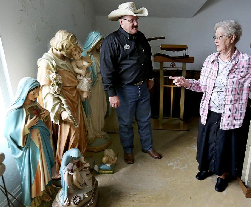 Sister Regina Schroeder and auctioneer Dennis Huggins walk through the chapel of the old St. Scholastica Monastery in Fort Smith. About 5,000 items from the monastery will be put up for auction Thursday through Saturday, and Huggins said he’s expecting 500 people each day. More photos are available at arkansasonline.com/512monastery/.