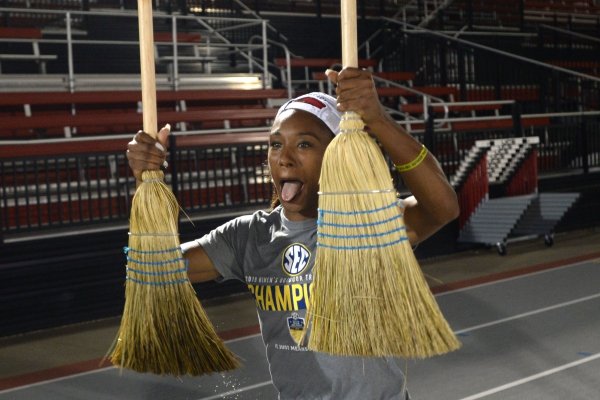 Arkansas' women's track and field athlete Kiara Parker celebrates with brooms Saturday, May 11, 2019, after winning the SEC Outdoor Track and Field Championship at John McDonnell Field in Fayetteville. Visit nwadg.com/photos to see more photographs from the meet.