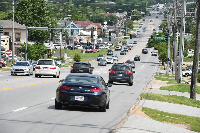 NWA Democrat-Gazette/J.T. WAMPLER Traffic flows Monday on College Avenue in Fayetteville. The city has released a first draft of the study for its U.S. 71B Corridor Plan. An open house is scheduled Tuesday.