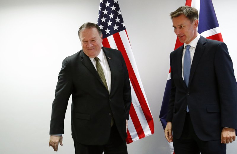 U.S. Secretary of State Mike Pompeo, left, poses with Britain's Foreign Secretary Jeremy Hunt at the European Council in Brussels, Monday, May 13, 2019. Secretary of State Mike Pompeo has changed the schedule for his latest trip to Europe, substituting a stop in Brussels for one in Moscow to discuss Iran and other issues with European officials. State Department spokesman Morgan Ortagus says Pompeo is still expected to meet Tuesday in Sochi with Russian President Vladimir Putin and Foreign Minister Sergey Lavrov. (Francois Lenoir/Pool Photo via AP)

