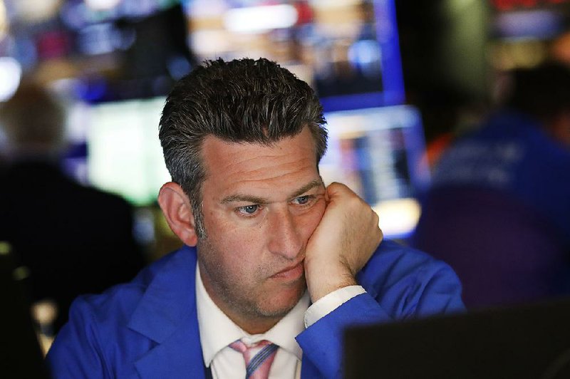 A trader watches stocks drop sharply Monday at the New York Stock Exchange as investors sought shelter from the escalating trade war between the U.S. and China. The Dow Jones industrial average fell more than 600 points on the day. 