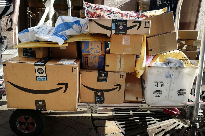 Amazon Prime boxes are loaded on a cart for delivery in New York in October. The company, which is trying to speed up its shipping times, said Monday it would fund up to $10,000 in startup costs and provide three months of pay to any employees who decide to quit and start their own Amazon delivery businesses. 