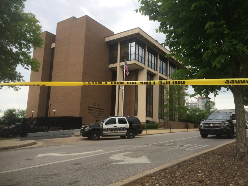 Police cars sit outside the John Paul Hammerschmidt Federal Building at 35 E. Mountain St. Fayetteville police are investigating a bomb threat at the site.