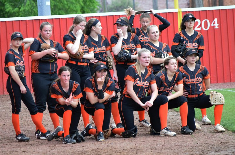 Westside Eagle Observer/MIKE ECKELS The Gravette Lady Lions gathered near the left-field wall to watch Clarksville warm up prior to the start of the first round of the 4A West regional tournament in Farmington May 2. The Lady Lions took the regional runner-up trophy May 5 and advanced to the second round of the state playoffs where the team lost to Brookland, 2-0.