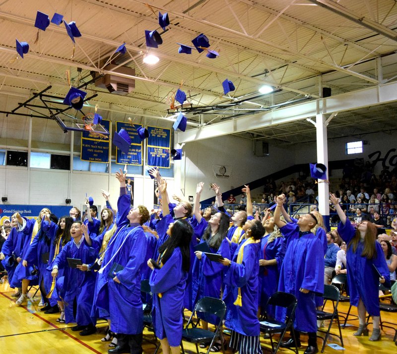 Westside Eagle Observer/MIKE ECKELS Decatur High School Class of 2019 graduates celebrate the end of a long 12-year journey by throwing their caps high into the air at Peterson Gym in Decatur May 10.