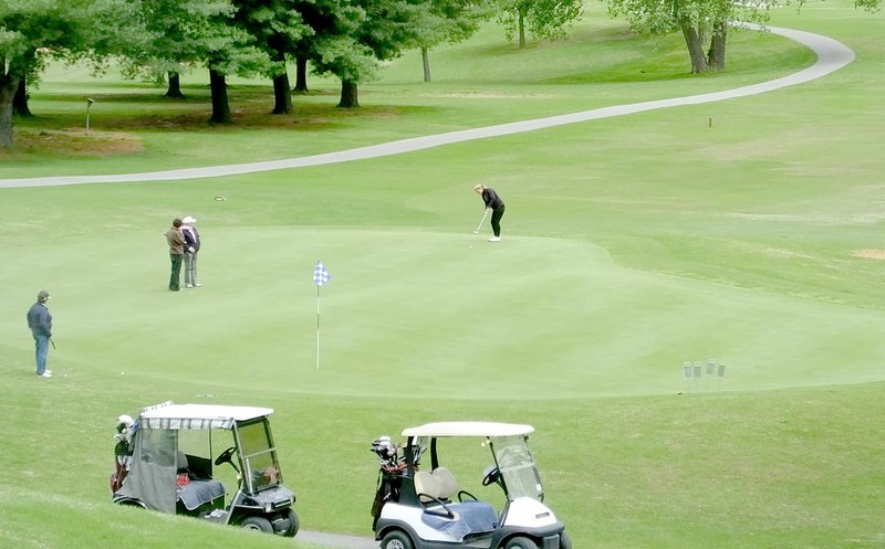 Lynn Atkins/The Weekly Vista Last week local golfers putted on the 18th green at the Country Club. During the Cooper Communities Charity Classic, young professional golfers will be on the course and spectators can have a comfortable view from the County Club patio.