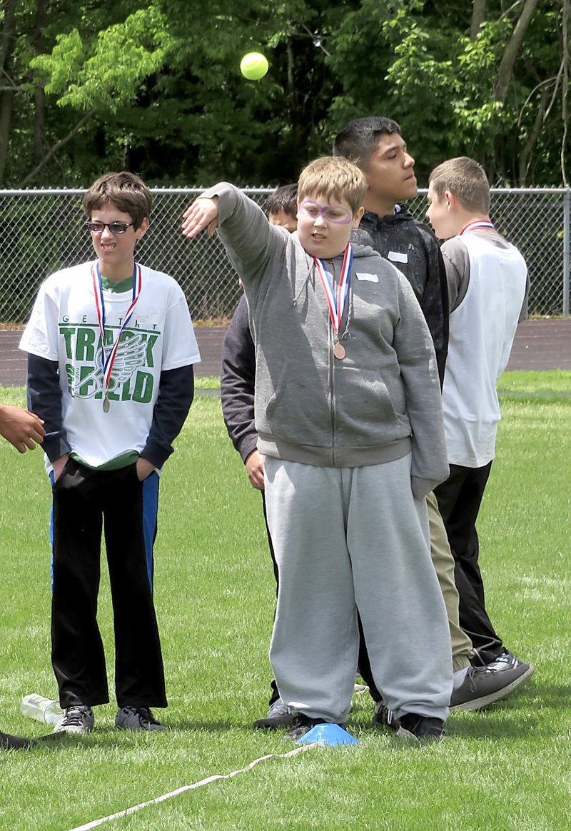 Westside Eagle Observer/RANDY MOLL Ethan Martin, a sixth-grade student from Siloam Springs, participates in the tennis ball throw during the special olympics held Friday in Gentry.