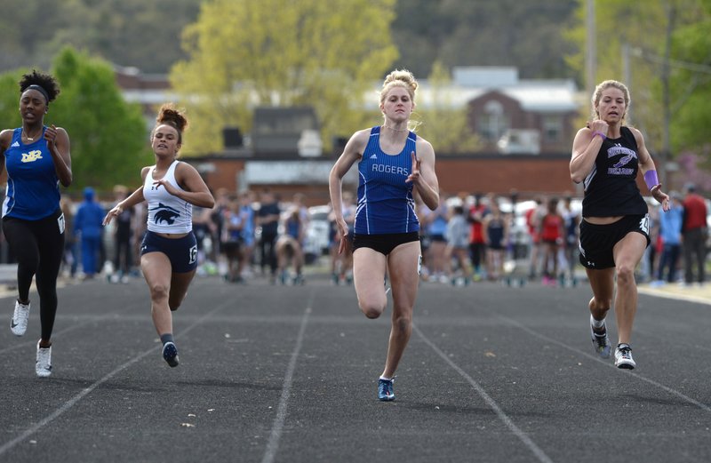 NWA Democrat-Gazette/ANDY SHUPE
Rogers senior Ashlyne Silcott (center) competes Friday, April 12, 2019, in the 100 meters alongside Madyson Dokes of North Little Rock (from left), Kania Starks of Har-Ber and Kristen Gibbs of Fayetteville during the Bulldog Relays at Ramay Junior High School in Fayetteville. Visit nwadg.com/photos to see more photographs from the meet.