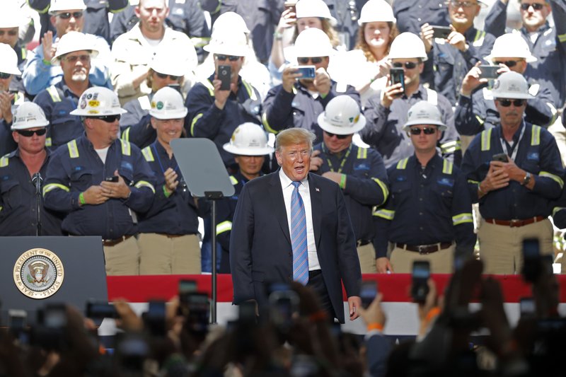 Workers applaud President Donald Trump as he arrives to speaks at the Cameron LNG Export Terminal in Hackberry, La., Tuesday, May 14, 2019. (AP Photo/Gerald Herbert)