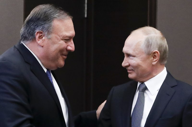 Russian President Vladimir Putin, right, and U.S. Secretary of State Mike Pompeo, greet each other prior to their talks in the Black Sea resort city of Sochi, southern Russia, Tuesday, May 14, 2019. Pompeo arrived in Russia for talks that are expected to focus on an array of issues including arms control and Iran. (AP Photo/Pavel Golovkin, Pool)