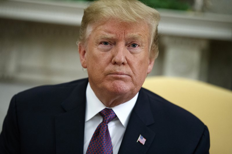 In this May 13, 2019, photo, President Donald Trump listens to a question during a meeting in the Oval Office of the White House in Washington. A federal judge in Washington is set to hold a hearing on May 14 on Trump's attempt to block a House subpoena seeking his financial records. (AP Photo/Evan Vucci)