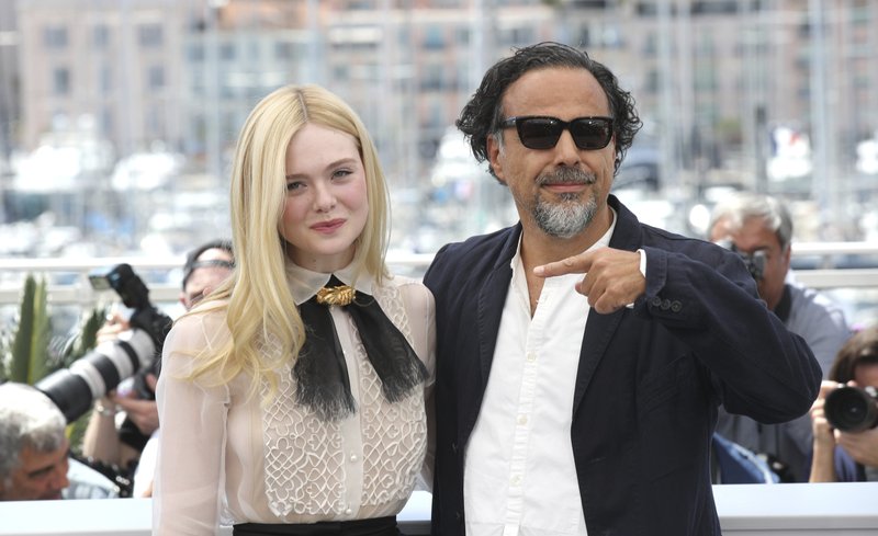 Jury member Elle Fanning, left, and jury president Alejandro Gonzalez Inarritu pose for photographers at the photo call for the jury at the 72nd international film festival, Cannes, southern France, Tuesday, May 14, 2019. 