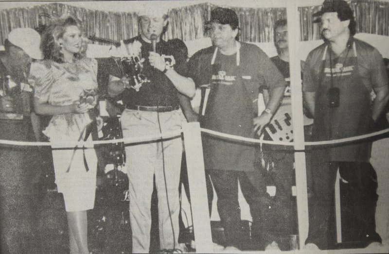  Arkansas Gov. Bill Clinton (middle, left) in a May 19, 1990, Banner-News photo awards the first-ever Governor’s Cup to Butch Long (middle right) and David Carmichael of Dumas at the Magnolia Blossom Festival and inaugural World Championship Steak Cook-Off. The festival itself began the year prior in 1989, but the cooking competition did not start until the event’s second year. It was designed to draw in more spectators to Magnolia and Columbia County and add to the festival’s prestige and scale.
