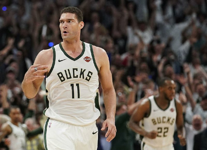 Milwaukee Bucks' Brook Lopez reacts to his three-point basket during the second half of Game 1 of the NBA Eastern Conference basketball playoff finals against the Toronto Raptors Wednesday, May 15, 2019, in Milwaukee. 