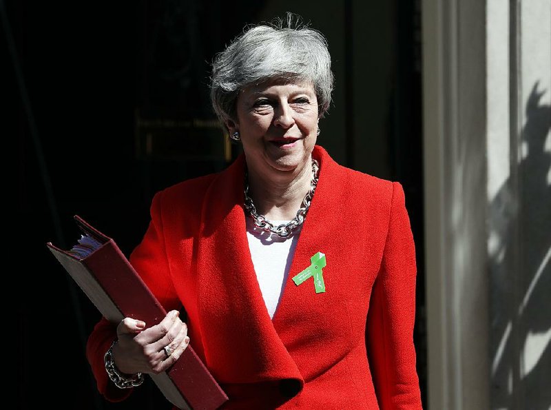 British Prime Minister Theresa May leaves No. 10 Downing St. in  London on Wednesday for her weekly prime minister’s questions session in the House of Commons. 