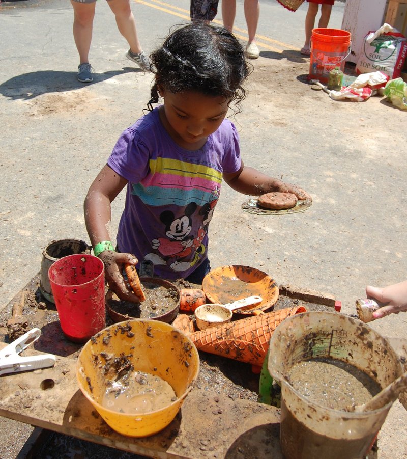 A young girl is hard at work whipping up her own creations in the Mud Kitchen, one of the hands-on activities at the Museum of Discovery's Messtival. Museum of Discovery
