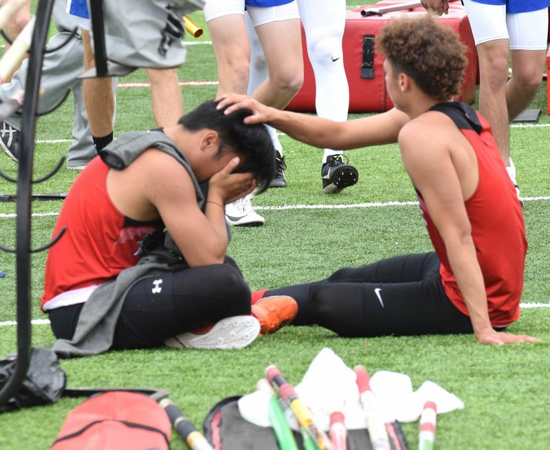 RICK PECK/SPECIAL TO MCDONALD COUNTY PRESS McDonald County pole vaulter Zach Woods consoles teammate Huechi Xiong after Xiong went out early in the event at the Missouri Class 4 District 2 Track and Field Championships on May 11 at Carl Junction High School. Woods, a two-time state qualifier, went on to clear 13-9, but finished in fifth place and failed to advance to this week's sectional meet in West Plains.