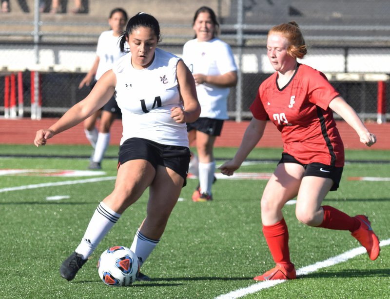 RICK PECK/SPECIAL TO MCDONALD COUNTY PRESS McDonald County's Nautica Gutierrez lines up a shot during the Lady Mustangs' 1-0 loss to Carl Junction in the Missouri Class 3 District 11 Girls' Soccer Tournament on May 13 at MCHS.
