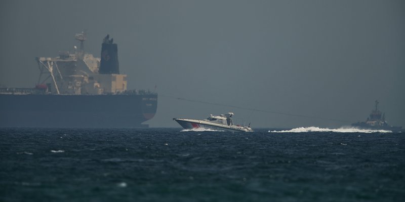 An Emirati coast guard vessel passes an oil tanker off the coast of Fujairah, United Arab Emirates, Monday, May 13, 2019. Saudi Arabia said Monday two of its oil tankers were sabotaged off the coast of the United Arab Emirates near Fujairah in attacks that caused &quot;significant damage&quot; to the vessels, one of them as it was en route to pick up Saudi oil to take to the United States. (AP Photo/Jon Gambrell)