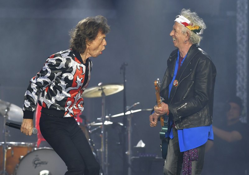 FILE - In this May 25, 2018 file photo, Mick Jagger, left, and Keith Richards, of The Rolling Stones, perform during their No Filter tour in London. The 75-year-old rocker on Wednesday, May 15, 2019 tweeted a video of him dancing around a studio in front of a mirror weeks after he underwent medical treatment, reportedly for a heart valve issue. The treatment forced the postponement of the Rolling Stones' No Filter tour.(Photo by Mark Allan/Invision/AP, File)