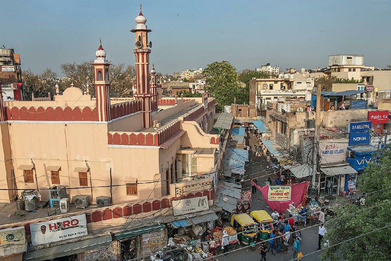 A poster expressing good wishes from the Muslim community during the smaller spring Navratri festival hangs at the entrance of a Gurugram meat market. 