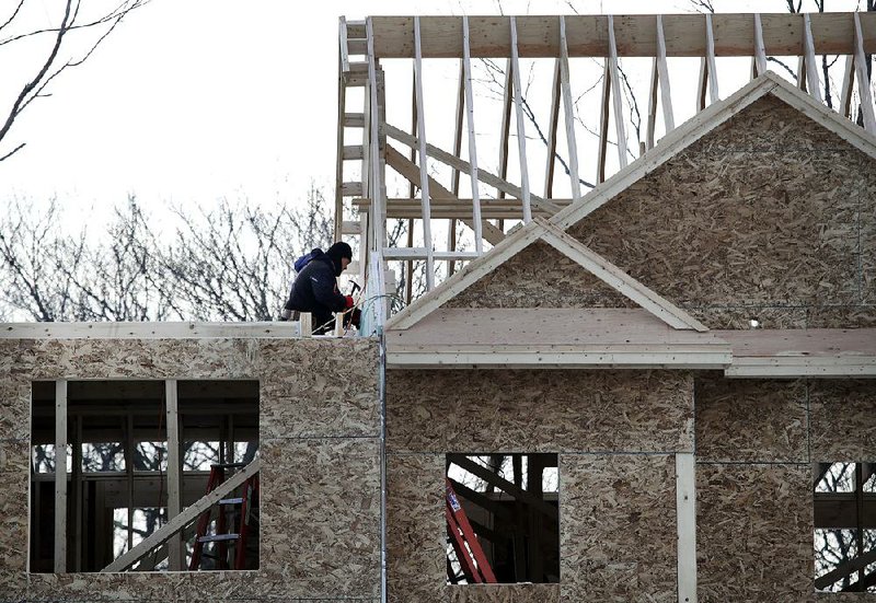 A construction crew works on a building early this year in Salisbury, Mass. U.S. housing starts rose in April as mortgage rates continue to fall, adding momentum in the housing sector. 