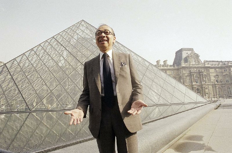 Architect I.M. Pei stands in front of the glass pyramid  he  designed that’s an entry for the Louvre in Paris. 