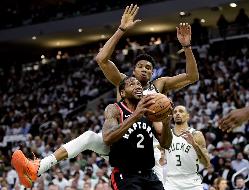 The Associated Press FORWARD FOUL: Toronto Raptors forward Kawhi Leonard (2) gets fouled by Milwaukee Bucks forward Giannis Antetokounmpo (34) during the second half of Wednesday's NBA playoffs Eastern Conference final in Milwaukee. Game 2 is tonight in Milwaukee.