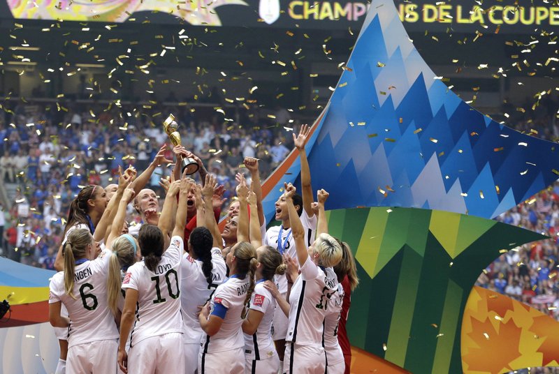 The Associated Press POSITIVE STEPS: Confetti floats down as the United States women's national team celebrate with the trophy on July 5, 2015, after beating Japan, 5-2, in the FIFA Women's World Cup soccer championship in Vancouver, British Columbia, Canada. When FIFA released its global strategy for women's soccer last year, it was met by some skepticism. But soccer's governing body is making some strides in implementing the long-range plan, against a backdrop of this summer's World Cup in France.