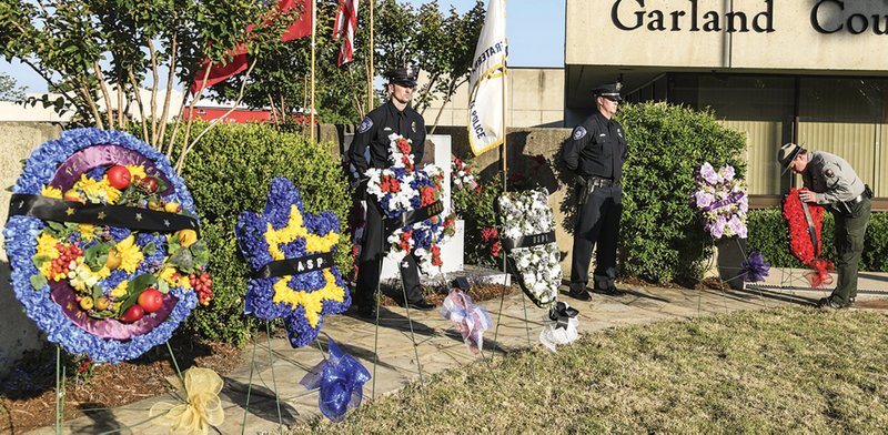 National Park Service Ranger Zach Summerlin places a wreath during the Fallen Officer Memorial Service at the Garland County Sheriff’s Department on May, 16, 2019. - Photo by Grace Brown of The Sentinel-Record