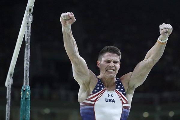 United States' Chris Brooks celebrates after performing on the parallel bars during the artistic gymnastics men's qualification at the 2016 Summer Olympics in Rio de Janeiro, Brazil, Saturday, Aug. 6, 2016. (AP Photo/Julio Cortez)