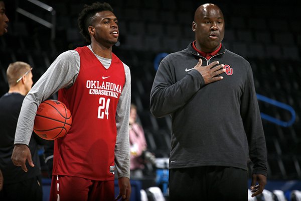 Oklahoma assistant Chris Crutchfield (right) talks with Oklahoma guard Buddy Hield during practice prior to the first round of the NCAA Men's Basketball Tournament at Chesapeake Energy Arena in Oklahoma City on Thursday, March 17, 2016.
