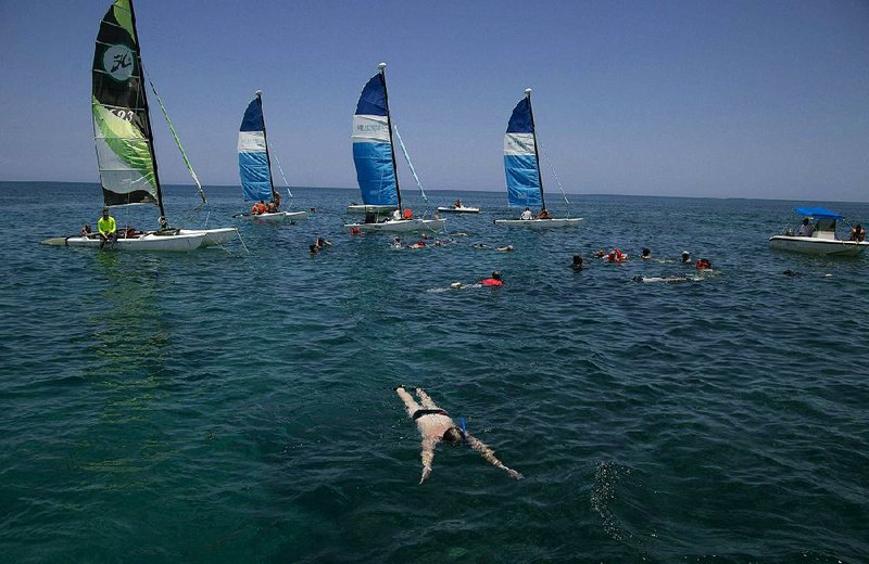 Tourists get in some snorkeling recently off a beach in Varadero, Cuba. The Cuban government has set a goal of drawing 5 million visitors this year. 