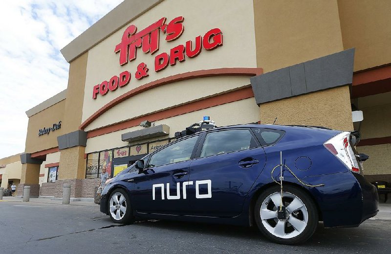 A self-driving Nuro vehicle parked outside a Fry’s supermarket, which is owned by Kroger, is part of a pilot program for grocery deliveries in Scottsdale, Ariz. 